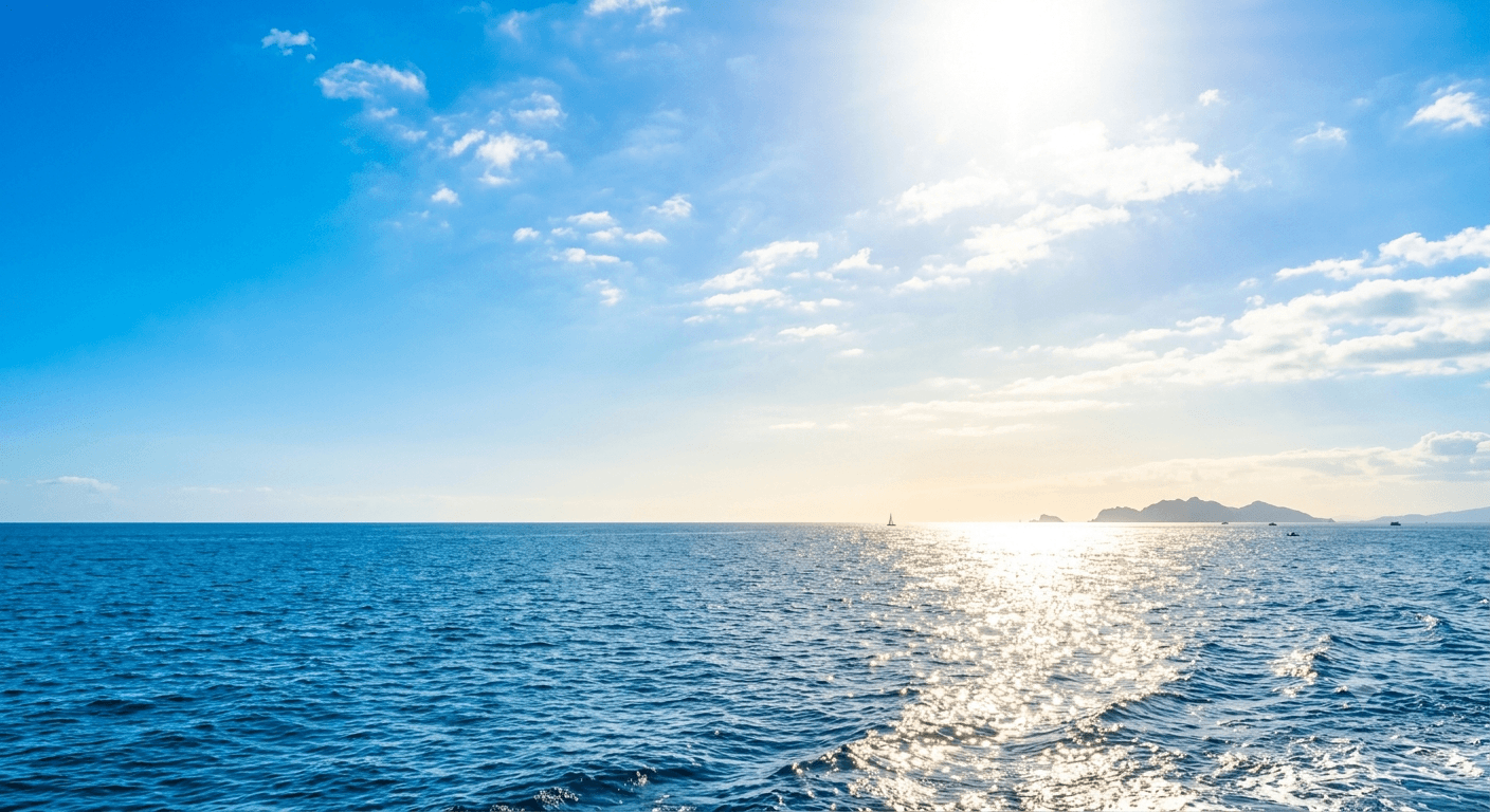 Open sky and sunlit sea stretching to the horizon